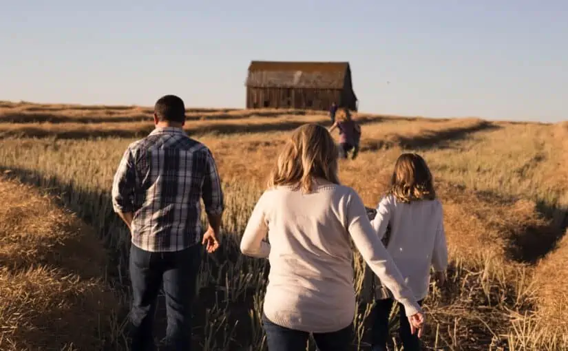 Family crosses a field while planning for emergencies or natural disasters